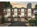 Charming townhomes featuring brick facades, attached garages, and well-maintained landscaping at 333 W 7Th St, Charlotte, NC 28202