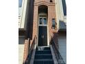 Elegant townhome front door with black hardware and brick surround at 333 W 7Th St, Charlotte, NC 28202