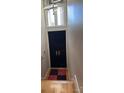 Black front door with glass transom window and gold hardware at 333 W 7Th St, Charlotte, NC 28202