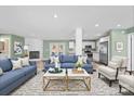 Open concept living area features a fireplace, stylish furnishings, light green walls and a seamless flow to the modern kitchen at 3433 Spinner Ct, Sherrills Ford, NC 28673