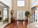 Inviting foyer featuring hardwood flooring, a staircase, and abundant natural light at 3533 Weddington Ridge Ln, Matthews, NC 28105