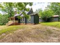 Charming home with green siding, brick foundation, and a covered porch, nestled in a serene outdoor setting at 3547 Willowood Pond Dr, Rock Hill, SC 29730