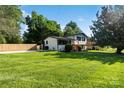 Expansive lush green front lawn with view of renovated home and fenced backyard at 4101 Tipperary Pl, Charlotte, NC 28215