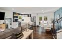 Open concept living space with hardwood floors, modern white kitchen, and stainless steel appliances at 4101 Tipperary Pl, Charlotte, NC 28215