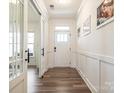 Bright hallway with wood floors, detailed trim work, and white paneled doors at 4535 Falls Lake Sw Dr, Concord, NC 28025