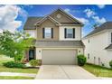 Inviting two-story home with a two-car garage, neutral siding, and well-maintained landscaping at 505 Silers Bald Dr, Fort Mill, SC 29715