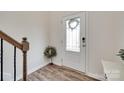 Bright foyer with wood floors, decorative wreath, and a staircase on the left at 505 Silers Bald Dr, Fort Mill, SC 29715