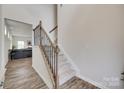 Inviting staircase with carpeted steps and decorative iron railing at 505 Silers Bald Dr, Fort Mill, SC 29715