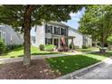 View of the home's exterior with a well-kept lawn, sidewalk, and charming front porch at 6029 Phyliss Ln, Mint Hill, NC 28227