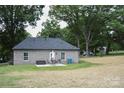 Backyard view with a patio set and well-maintained lawn at 604 E Ohio Ave, Bessemer City, NC 28016