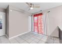 Neutral bedroom with tile floors, ceiling fan, and natural light from the window at 6113 Windsor Gate Ln # 6113, Charlotte, NC 28215