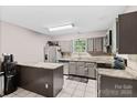 Functional kitchen featuring gray cabinets, stainless steel appliances, and granite countertops at 6113 Windsor Gate Ln # 6113, Charlotte, NC 28215