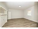 Spacious bedroom with wood-look floors, natural light, and a classic fireplace at 613 E Liberty St, Salisbury, NC 28144