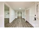 Bright hallway featuring wood-look floors, crisp white trim and neutral walls at 613 E Liberty St, Salisbury, NC 28144