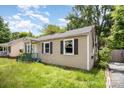 One-story home with a broken window and a green porch, set on a large lot at 638 E Black St, Rock Hill, SC 29730