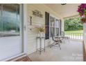 Cozy front porch area with chairs, plants, and decorative touches for a welcoming feel at 713 Hickory Hill Ct, Gastonia, NC 28054
