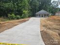 Newly constructed single-Gathering home with a concrete driveway, offering a modern and inviting facade at 814 Generation Ln, Clover, SC 29710