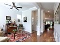 Inviting living room with hardwood floors, a ceiling fan, and a hallway with views into other rooms at 914 Greenbridge Dr, Matthews, NC 28105