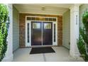 Inviting front entrance featuring a stylish double door, stone accents, and a welcoming porch area at 9330 Carneros Creek Rd, Charlotte, NC 28214