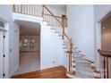 Staircase featuring wood and carpet steps and white wood railing and trim at 10408 Hadleigh Pl, Charlotte, NC 28210