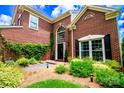 Welcoming brick home featuring a bright front entrance and a beautifully landscaped front yard at 10418 Pullengreen Dr, Charlotte, NC 28277