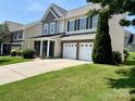 A beautiful two-story home with an attached two-car garage and a spacious driveway at 11511 Wilson Mill Ln, Pineville, NC 28134