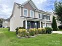 Beautiful two-story home with manicured landscaping and a welcoming front yard at 11511 Wilson Mill Ln, Pineville, NC 28134