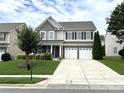 Attractive two-story home showcasing a well-kept lawn and a two-car garage at 11511 Wilson Mill Ln, Pineville, NC 28134