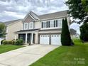 Charming two-story home featuring a two-car garage and a well-maintained lawn at 11511 Wilson Mill Ln, Pineville, NC 28134