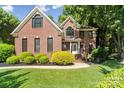 Charming two-story brick home with well-manicured lawn and mature landscaping at 121 Canterbury Xing, Fort Mill, SC 29708