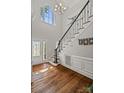 Bright foyer featuring hardwood floors, a staircase, and a decorative front door at 121 Canterbury Xing, Fort Mill, SC 29708