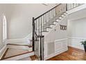 Elegant staircase with decorative iron railings and hardwood floors in a well-lit foyer at 121 Canterbury Xing, Fort Mill, SC 29708