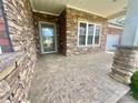 Spacious covered front porch with stone pillars and patterned concrete flooring, perfect for outdoor enjoyment at 1302 Devonmere Pl, Salisbury, NC 28144