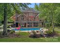 Backyard boasts a refreshing pool, fire pit, and outdoor seating for relaxation and entertainment at 1317 Longleaf Ct, Matthews, NC 28104
