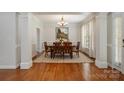 Elegant dining room with hardwood floors, chandelier, and view to the landscaped backyard at 14746 Greenpoint Ln, Huntersville, NC 28078