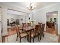 Stylish dining area featuring hardwood floors, decorative columns, and views into the office and kitchen at 14746 Greenpoint Ln, Huntersville, NC 28078