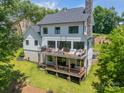 Expansive back of home featuring dual decks with seating areas and a well-maintained lawn at 1543 Withers Dr, Denver, NC 28037
