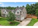 A charming home featuring stone accents, a well-manicured lawn, and an inviting driveway at 231 Anvil Draw Pl, Rock Hill, SC 29730