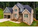 Stunning two-story brick home with a well-manicured lawn and inviting front entrance at 236 Mark Ryan Ln, Dallas, NC 28034