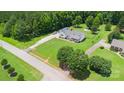Spacious property showcasing a well-maintained home, lush landscaping, and an expansive driveway at 250 Wesley Amaker Rd, York, SC 29745