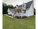 Charming home with a covered front porch, an American flag, and well-maintained landscaping at 250 Wesley Amaker Rd, York, SC 29745