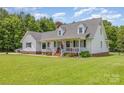 Traditional home with a welcoming front porch, manicured lawn, and mature trees surrounding the property at 250 Wesley Amaker Rd, York, SC 29745