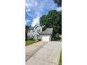 Well-maintained two-story home with an attached garage and a green lawn at 4221 Hounds Run Dr, Matthews, NC 28105