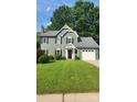Inviting two-story home with a lush lawn and a covered front entrance at 4221 Hounds Run Dr, Matthews, NC 28105