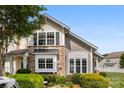 Attractive townhome showcasing a stone facade, well-maintained landscaping, and plenty of natural light at 448 River Park Rd, Belmont, NC 28012