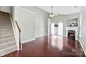 Bright living room features hardwood floors, a cozy fireplace, and a ceiling fan at 448 River Park Rd, Belmont, NC 28012