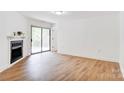 Living area has wood floors, a fireplace and sliding doors leading to the outside at 4806 Spring Lake Dr # D, Charlotte, NC 28212