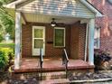 Welcoming front porch with ceiling fan, offering a comfortable outdoor space at 5722 Oak Dr, Charlotte, NC 28216