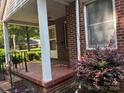 Inviting covered porch with brick flooring, ideal for enjoying the outdoors at 5722 Oak Dr, Charlotte, NC 28216