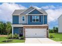 Charming two-story home with stone accents, manicured landscaping and a two-car garage at 7008 Jerimoth Dr, Charlotte, NC 28215